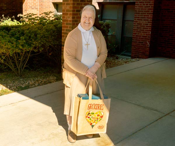 A sister with a reusable grocery bag.