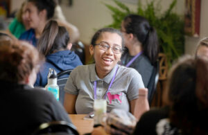 Young women perform service at a ministry.
